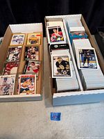 open two-row card storage box showing loose stacks and sleeved cards