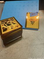 Stacked hockey cards in amber cases next to blue binder