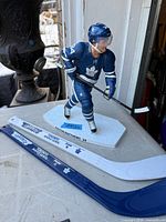 Front view of Auston Matthews figurine and two mini sticks