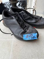 Top view of both black Nike shoes with laces visible