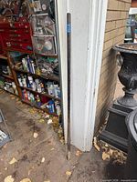 Full view of 54" steel pry bar leaning against doorway