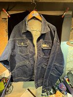 Front view of blue Rocawear denim jacket showing pockets, zipper and overall condition