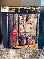 Front cover of Styx "The Grand Illusion" LP showing album artwork and overall sleeve condition