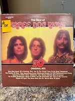 Front cover of The Best of Three Dog Night vinyl LP showing title, band photo, tracklist and price sticker