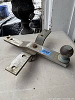 Overall view of steel trailer hitch ball mount with attached tow ball showing receiver shank and mounting holes