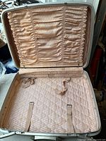 Interior showing peach quilted satin, ruched pockets, straps