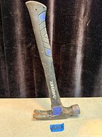 Full view of Husky claw hammer showing head, handle, and wear