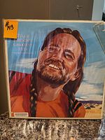 Front of Willie Nelson Greatest Hits album showing illustrative cover art