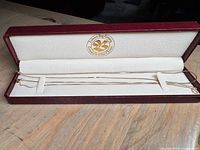 Two gold necklaces displayed in Hudson’s Bay Company case
