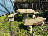 Full view of concrete garden table with three matching benches