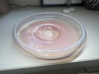Top angled view of opalescent pink glass bowl showing swirl center
