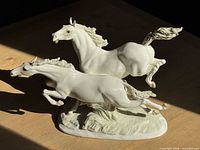 Front left view showing both galloping horses on base