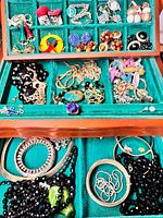 Open jewellery box showing contents in both tray and bottom compartment