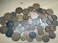 assortment of bronze British coins spread on table