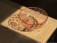 overall view of pink depression glass footed bowl in sunlight