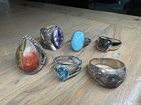 All five silver rings grouped on tabletop