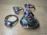 Five sterling silver amethyst rings, assorted styles