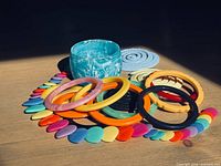 assortment of bangles, necklace, discs displayed together