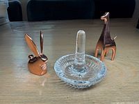 Three ring holders: Waterford crystal dish with peg, Umbra copper rabbit, Umbra copper giraffe
