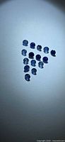 Triangular arrangement of fifteen round blue sapphires