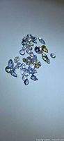group of loose multicoloured faceted tanzanite gemstones on neutral background