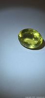 Top view of faceted oval lemon citrine showing color and cut
