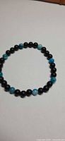 Bracelet laid flat showing alternating black and blue beads