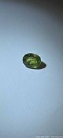 Front view of faceted green sapphire