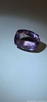 Cushion-cut amethyst angled view showing brilliance and purple color