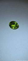 Front view of oval peridot loose stone