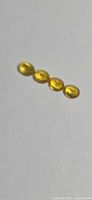 Four oval yellow sapphires on neutral background