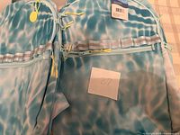 Two blue Riley backpacks front view with tag and lot note