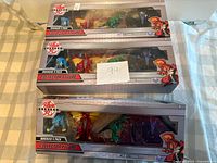 Front view of two sealed Bakugan 4-Pack Collector Figure sets
