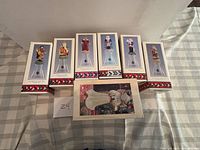 Seven boxed Hallmark items displayed on table