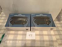 Front view of two boxed Vivitar Netra wireless speakers