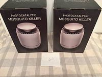 Front view of two boxed photocatalytic mosquito killers