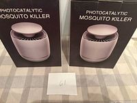 Front view of two unopened Photocatalytic Mosquito Killer boxes