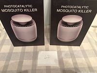 Front view of two boxed photocatalytic mosquito killers