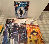 Group shot of ten Captain Marvel comics laid out on table