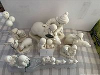 Overview of eight Snowbabies figurine groups