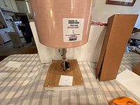 Front view showing Room Essentials label on pink drum shade and base