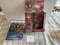 Overall shot of sealed Mick figure on card and boxed Pounder vehicle