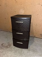 Front angle view of the dark brown plastic three-drawer organizer
