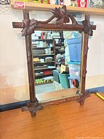 Front view showing full carved frame and mirror glass