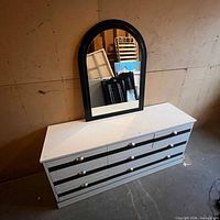 Full view of dresser front with attached mirror showing drawer layout and color contrast