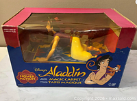 Front view of boxed Aladdin Magic Carpet battery-operated toy
