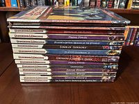 Stack of D&D 4e softcover books showing cover of Scepter Tower of Spellgard and spines of others