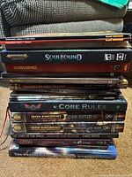 Full stack of rulebooks showing spines and titles