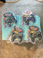 All four sealed handheld games on surface