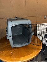 Open front view showing interior, metal wire door, latch, and overall structure